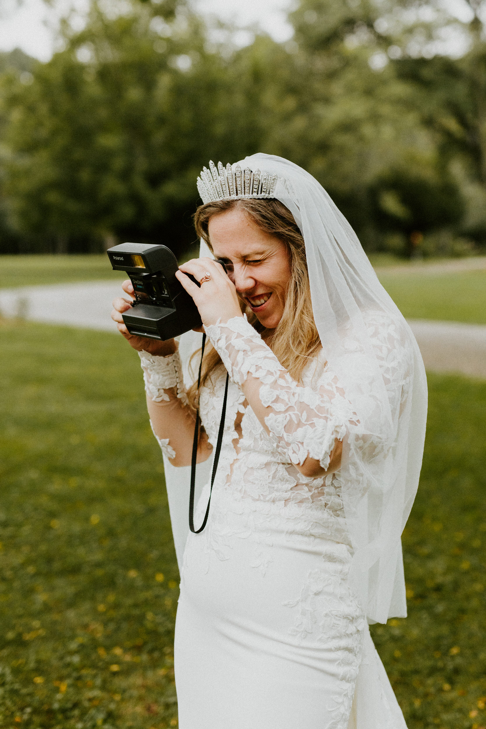 bride with polaroid camera