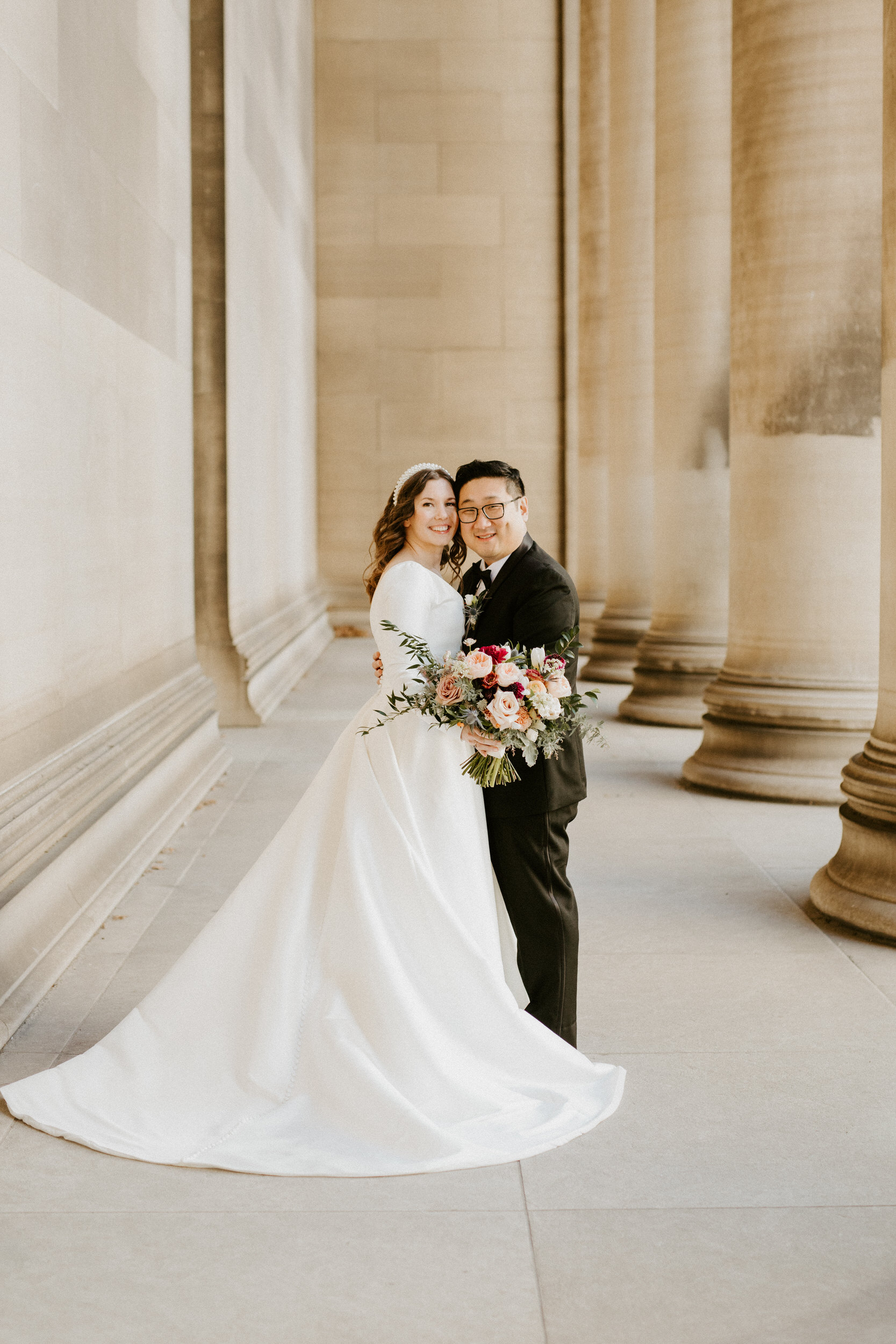 bride and groom at the mellon institute columns