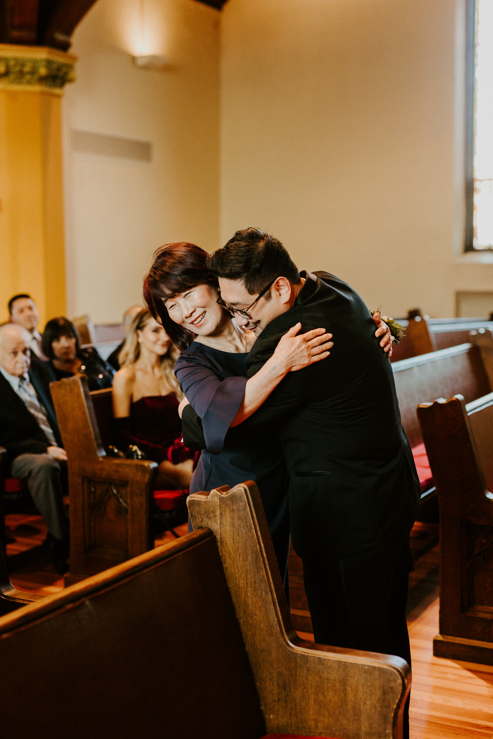 groom and his mom hugging in church